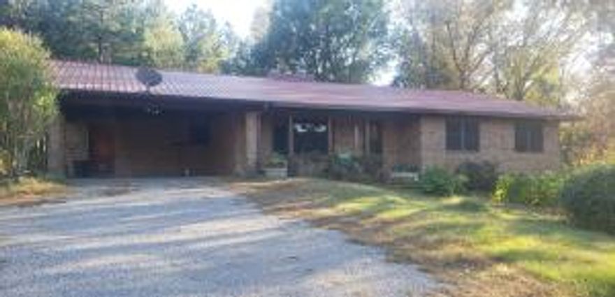 Tucked away secluded home just outside of Dover City limits. This 3 bedroom 2 bath, over 4000 sf home is nestled away from the highway on 30.43 acres planted in pines. Home features a full unfinished basement (with  a fire place, roll up door, as well as plumbed for an additional bathroom. New owner could expand or make this space their own. Owner will be conveying a full sized pool table in this space. Above ground pool with a deck and pool house. 2 Additional detached carports 20x30 and 18x21 for your boat RV or additional cars and toys. There are also additional storage buildings.  Pine trees should be mature for logging in less than 5 years if interested. There is also an additional 24 X 70 Commercial building close to the highway to is also included.