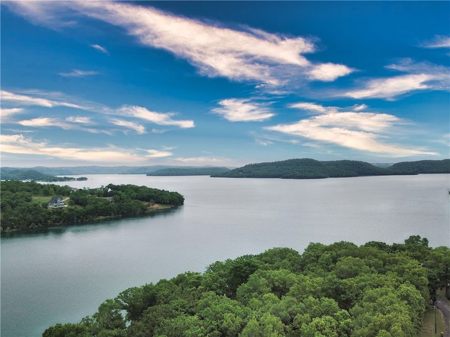 Charming lakefront property nestled on 2 spacious lots totaling 1.08 acres. This property includes a private covered boat dock with 2 10’X24’ ft boat slips and around 172 feet of shoreline. An expansive deck located off the living room looks out onto beautiful Beaver Lake. After a day on the lake, you will be able to conveniently utilize the outdoor shower. Most furniture will convey. Paved roads lead to this home while located only a quick 20 minute drive to Rogers. Make this property yours to reach its full potential of a lake house dream home!