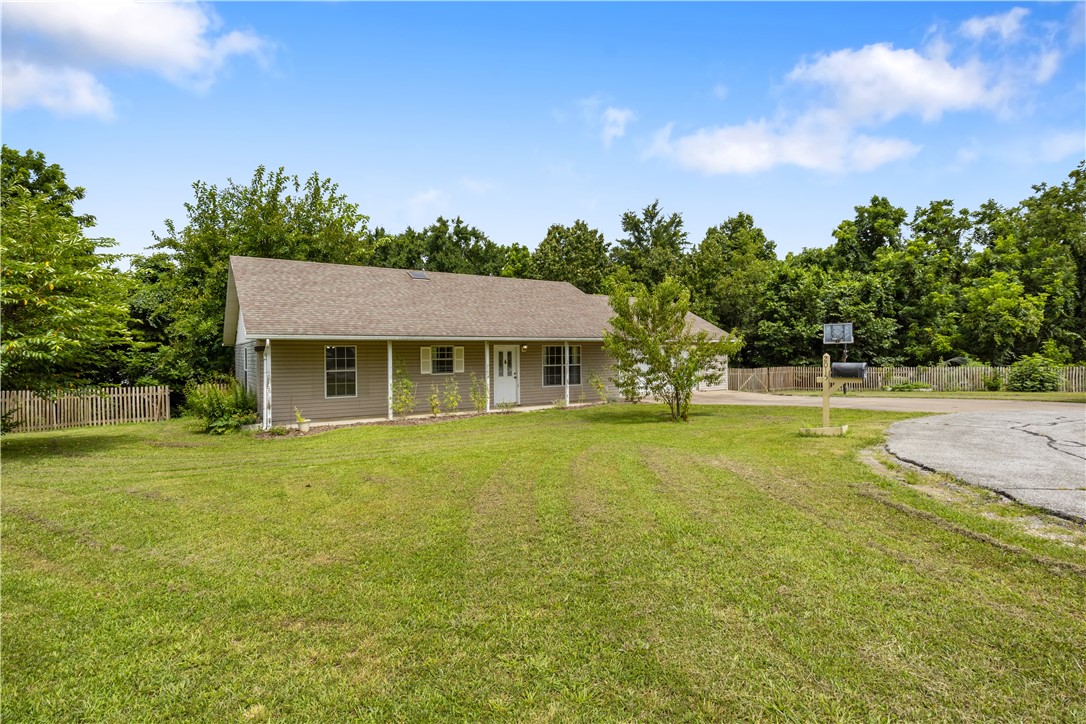 Welcome to your dream scenario in Pea Ridge! On just over an acre, in town, and a gardener's paradise. This home features numerous fruit trees and bushes; mulberry, black walnut, fig, elderberry, plum, thornless blackberry. Morrell mushrooms also typically grow along the fence line in the spring. There is also a chicken run that will convey as well. Many different species of wildlife have been spotted in the backyard including fox, birds, deer, raccoons, rabbits, turtles, armadillos, and frogs. This home features 3 bedrooms, the master has an attached bath. The secondary bathroom features a skylight that brings in the perfect amount of natural light. This home is looking for the perfect family to come love all of its amazing features! Washer, dryer, and fridge will convey as well.