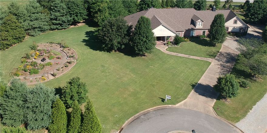 Builder's custom personal home in amazing East Fayetteville on large 2-acre lot located by the beautiful White River. New roof (2020) 5 Bed, 7 Bath, 6569 sq ft. including updated kitchen, executive living quarters, oversized 4-car garage, full mother-in-law suite with private bath, bonus room, private courtyard with outdoor fireplace, beautiful landscaping, rose garden and SO much more! Enjoy the heated floors in the primary bathroom leading to the oversized primary closet with island. Use the large butlers pantry and full bar in the living room to entertain guests as they prepare for a canoe trip on the White River with the boat launch just 1/8 mile away. Listings in Bordeaux Village are rare so don't miss your chance at this one!