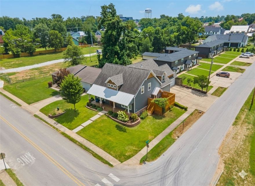 Walkable downtown Bentonville living just minutes from the Square, Crystal Bridges, parks, schools, and the Razorback Greenway. This Craftsman-style home offers refined, lock-and-leave luxury with rare entertaining amenities, including a private terrace & hot tub, wine cellar/speakeasy, and fitness space—ideal for executives or professionals seeking convenience.

With 4,148 sq ft across three thoughtfully designed levels, the main floor features wood beams, custom built-ins, hardwood floors, and a chef’s kitchen with granite counters, dual ovens, farmhouse sink, and walk-in pantry. The main-level primary suite includes a spa bath, walk-in closet with laundry access, and private terrace. Upstairs offers 2 bedrooms, 2 full baths, and a bonus/media room. The finished lower level features a custom wine cellar, tasting room, and fitness space. The corner-lot setting provides curb appeal, with nearby parks, trails, splash pad, and seasonal ice rink for your outdoor recreation without the maintenance of a large yard.