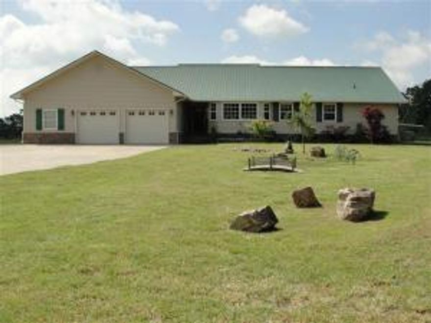 Beautiful large home on 18 secluded acres just at the edge of town. Solid Hardwood floors throughout with laminate in the kitchen and carpet in the family room. Dining room is used as an office now, but also has a separate office space. All electric HVAC with zoned heat pump. Well, septic, 8x10 storm shelter, Cable TV, high speed internet. Wood stove for back up heat.  Wired for generator whole house speakers. 30x40 metal shop with 12' equip overhang. Shop has AC, 220 power, loft and concrete floor. Included is a 17x30x5 ft. above ground pool with deck. Owners also built an 18x30 pavilion with metal roof, concrete floor, and electricity. Lane to the property is an easement.