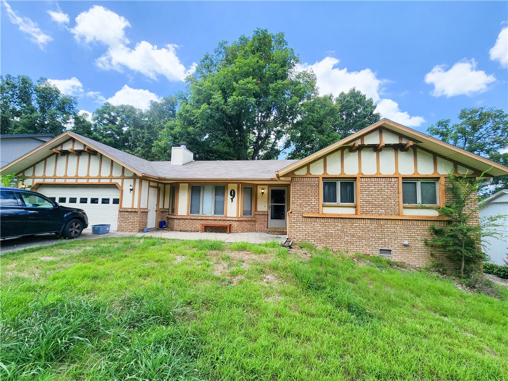 Charming 2-bed, 2-bath home in a quiet Bella Vista neighborhood with great potential! This single-level property offers a spacious layout with vaulted ceilings, a wood-burning fireplace, and a formal dining area. The primary suite features ample closet space and a private bath. Enjoy relaxing or entertaining on the large back deck overlooking a wooded backyard. Home includes an oversized 2-car garage and sits on a low-maintenance lot. Flooring is in good shape, but the home could use some interior paint and minor repairs. Priced accordingly and being sold as-is, but seller is open to all offers. Great opportunity to personalize and build equity in a desirable location close to trails, golf, and lakes. Whether you're a first-time buyer, investor, or downsizing, this home offers a solid foundation to make your own. Don’t miss your chance to own a great home in Bella Vista!