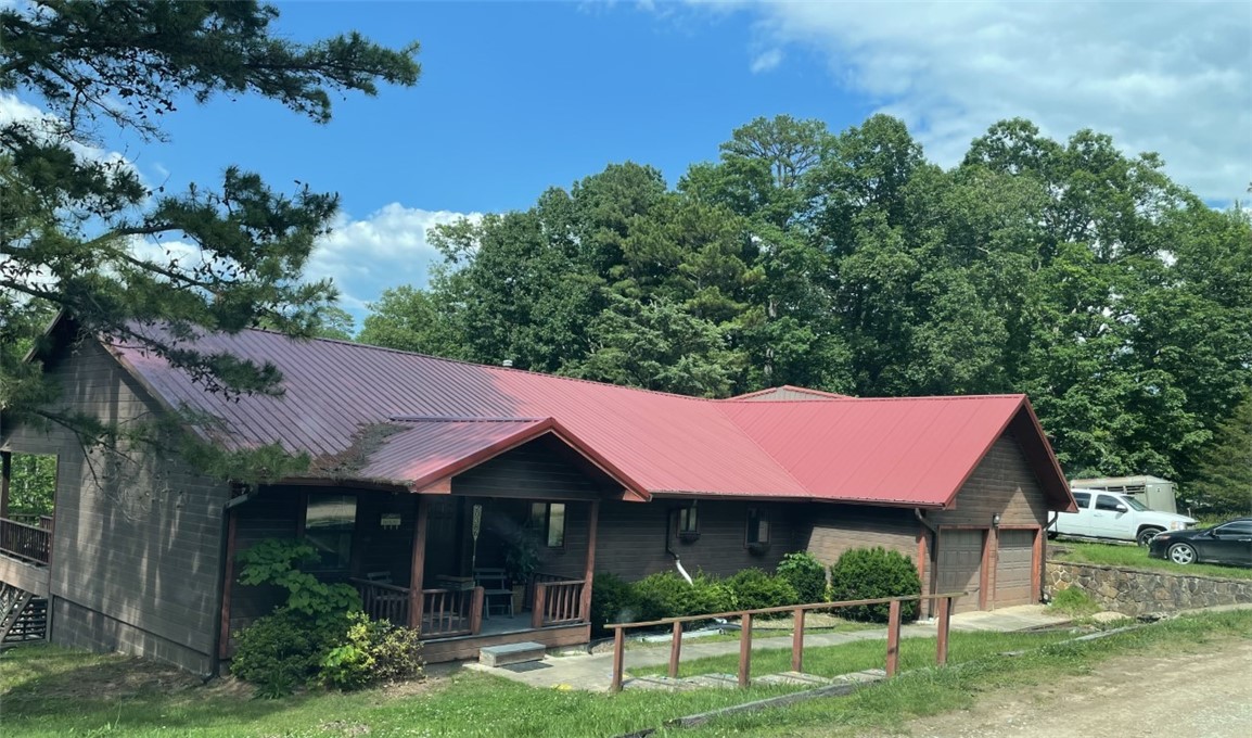 Lake front!!!!! Amazing view overlooking Beaver Lake and Rocky Branch Marina. Whether its your residence, vacation home, rental, or AirBnB the possibilities are endless. The large deck is perfect for entertaining. This property is over a half acre on the water! With 2,700 sf under roof you can find plenty of room for anything you want. There is also an attached 2 car garage....but in addition to that there is a 1,500 sf detached workshop.