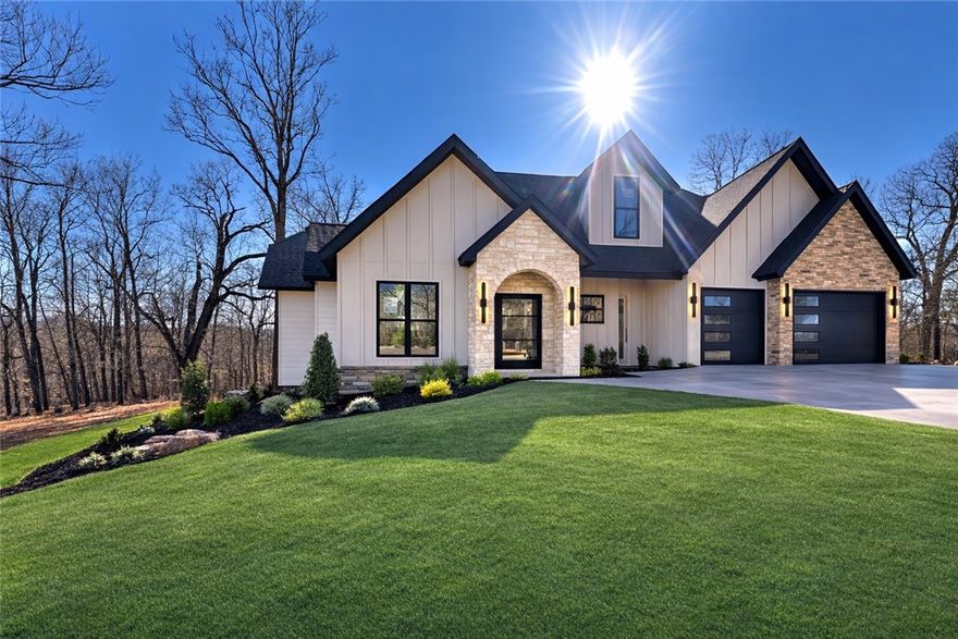 Welcome to this beautiful farmhouse in The Hollows at Beaver Lake—where peaceful living meets everyday convenience just minutes from Downtown Rogers. Nestled on a beautiful 1-acre lot, this spacious 2-level home offers 3,135 sq ft with a walk-out basement and a 3-car garage. Inside, you’ll find thoughtfully designed living spaces including an office, den, and inviting living room. Cathedral ceilings, granite countertops, built-ins, and large walk-in closets bring both style and functionality. The home also features a pantry, laundry room, and attic storage for added convenience. Need extra space? The bonus room and game room can easily serve as a media room, home office, or playroom. Step outside to enjoy multiple outdoor living areas including a balcony, covered deck, patio, and porch—perfect for relaxing or entertaining. With classic brick and rock exterior accents and room to spread out, this home offers comfort, versatility, and the lifestyle you’ve been looking for.