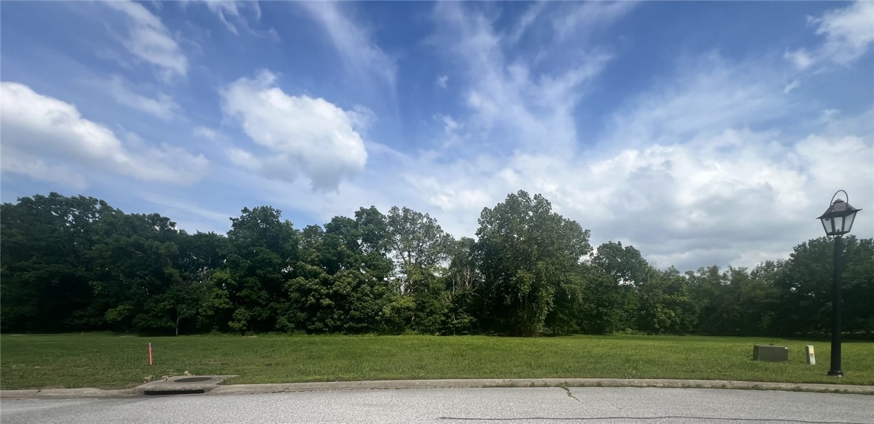 Two combined lots totaling 2.38 acres with creekside access in the picturesque Beau Chalet of Northwest Arkansas. Enjoy old-world charm and luxurious estate living within this private and tranquil gated community featuring expansive lots. Abundant wildlife enhances the natural beauty of area. Located just minutes from XNA, and Pinnacle shopping, with convenient access to Washington County. This property falls within the Bentonville Public School district.