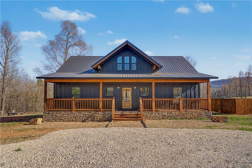 **$3,500 preferred lender credit** Discover an incredible luxury vacation & investment gem in Jasper, Arkansas—a charming mountain town rich with adventure and small-town charm in the heart of the Ozarks. This brand-new construction 3-bed, 2-bath home is located 4 miles from the Jasper town square. The exterior makes a striking first impression with black board-and-batten siding, stone accents, & warm stained wood details. Step inside to find a thoughtfully designed interior featuring cottage-style finishes paired with modern amenities and an inviting open-concept layout. Unwind on the decks while taking in mountain ridge views or gather around the firepit for relaxing evenings under the stars. Located near shopping, restaurants, hiking, biking, camping, floating the Buffalo National River, zip-lining, rock climbing, and more. Perfect as a full-time residence, vacation retreat, or Airbnb, this property delivers mountain living at its best—with the conveniences of a larger city close by.
