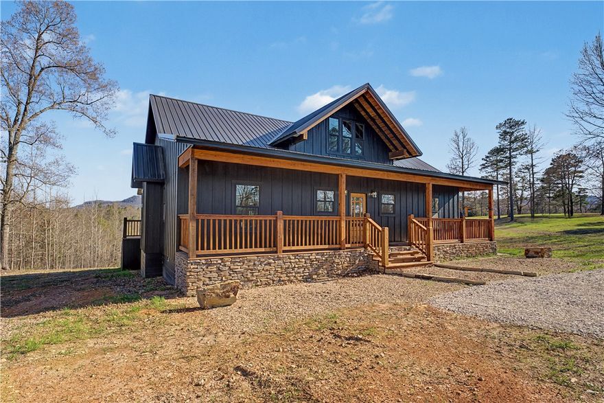 Discover an incredible luxury vacation and investment gem in Jasper, Arkansas—a charming mountain town rich with adventure and small-town charm in the heart of the Ozarks. This brand-new construction 3-bed, 2-bath home is located 4 miles from the Jasper town square. The exterior makes a striking first impression with black board-and-batten siding, stone accents, and warm stained wood details. Step inside to find a thoughtfully designed interior featuring cozy cottage-style finishes paired with modern amenities and an inviting open-concept layout. Unwind on the spacious decks while taking in mountain ridge views, or gather around the firepit with Adirondack chairs for relaxing evenings under the stars. Located near shopping, restaurants, hiking, biking, camping, floating the Buffalo National River, zip-lining, rock climbing, and more. Perfect as a full-time residence, vacation retreat, or high-performing Airbnb, this property delivers mountain living at its best—with the conveniences of a larger city close by.