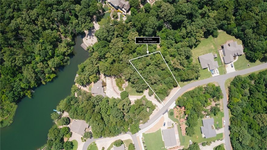 PERC TEST ALREADY COMPLETED! Imagine your future home on this .54-acre lot, ideally positioned in a peaceful setting with lake access via common property directly behind it. Lake views from the property currently but could be even better depending on house style selected.
 • Gently sloping terrain, ideal for a walkout basement or a variety of custom home designs
 • Lake access just steps away through well-maintained common property
 • Completed soil percolation test, saving you time and money
 • A quiet, scenic environment perfect for full-time living or a relaxing weekend retreat
Bring your building plans and make your lake-area dream a reality. With the perc test complete and the rare benefit of community lake access, this property is ready for your vision. Don’t miss this exceptional opportunity! Come enjoy all that Bella Vista has to offer in one of the most sought after areas on Loch Lomond. Golf courses, restaurants, marina, trails and parks are all nearby! Come see this stunner today.