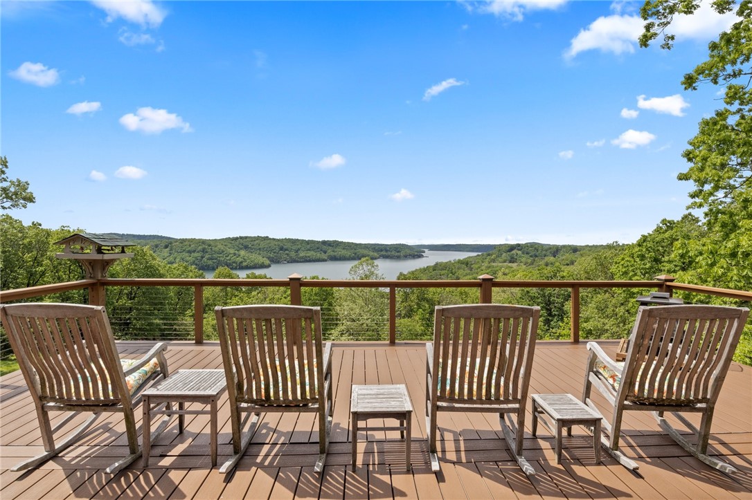 Discover the perfect blend of rustic charm and modern luxury in this custom-built log home, situated on an expansive 3.45 acres with breathtaking views of Beaver Lake. Spanning an impressive 3,782 square
feet, this residence showcases everything you are looking for in a home on the lake. The open-concept design features soaring ceilings and large windows offering stunning sights from nearly every room. The home is surrounded by beautifully manicured flower beds, each one thoughtfully arranged and bursting with color. In addition to the listed square footage, there's an extra 736 sq.ft. currently being used as a wood shop. This versatile space offers endless possibilities-with perfect potential for anything you can envision- a studio, gym, guest suite, game room, etc. Spend your days boating, fishing, swimming off the dock or simply relaxing and taking in the serene views from your screened-in porch. This is more than a home, it's the lifestyle you've been dreaming of. Come see it for yourself!