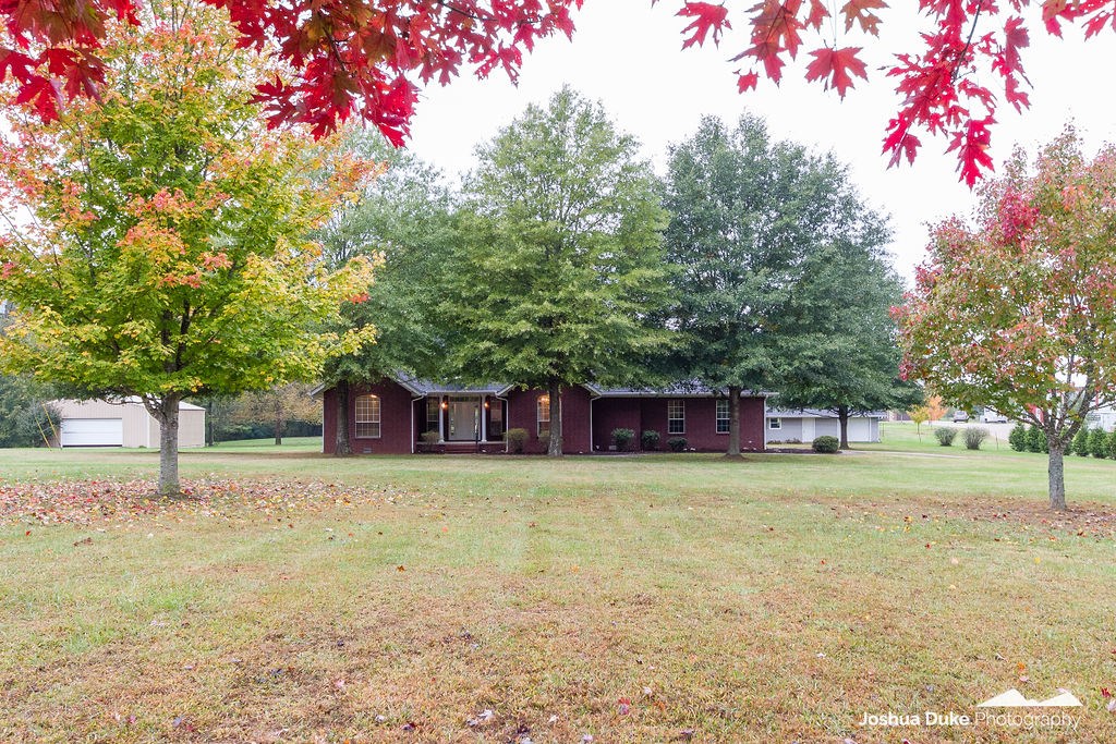 Very well maintained 1 owner home on nearly 4 Acres. 3 Bedrooms, 2.5 Baths on one level. ALL brick so very low maintenance. Mostly Hardwood floors. Detached building with shop and 1 vehicle garage.
