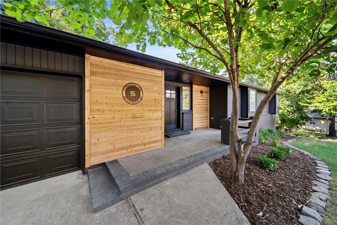 Freshly remodeled and move-in ready, this 3-bedroom, 3-bathroom Bella Vista home blends modern style with everyday functionality. Inside, the kitchen stands out with custom cabinetry and sleek quartz countertops, opening to bright living spaces with hardwood floors upstairs and LVP flooring downstairs. The primary suite is a true retreat, featuring a large walk-in closet and a beautifully updated tile shower. Throughout the home, you’ll also find ample storage for easy organization. Enjoy multiple living areas including a sunroom filled with natural light and a lower-level bonus space with a wet bar, perfect for entertaining, game nights, or a private retreat. Step outside to relax on the covered patio or in the fenced backyard, ideal for pets, gatherings, or quiet evenings outdoors. With its fresh exterior, stylish finishes, and versatile floor plan, this home captures the best of Bella Vista living.