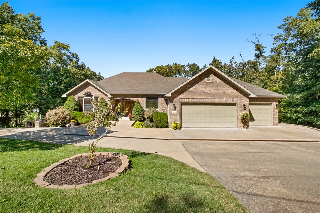 Welcome Home to this 3-bedroom (with office), 3-bath two-story property on Lake Brittany in Bella Vista. With a private dock, 2 levels of living space & 2 large decks, this home is perfect for entertaining & enjoying all that lake life has to offer. The primary suite is on the main level. The lower level currently serves as a lucrative Airbnb suite, complete with kitchenette, 1 bedroom/1 full bath, a dining area & large entertaining space. The air-conditioned workshop on the lower level is a craftsman's dream. There's potential to convert shop & storage to add'l living space. This property combines the charm of lakeside living with income-generating potential. Custom cabinets throughout. The 3-car garage has room for your side by side, boat or 3rd car. As a Bella Vista resident, you'll enjoy access to all that Bella Vista has to offer ... golf courses, clubhouses, restaurants, marinas and world class mountain bike trails, all designed to enhance your quality of life.