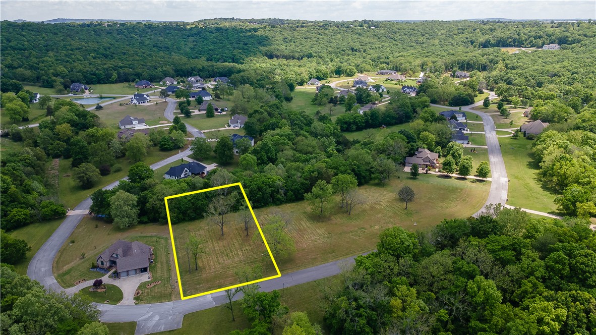 Build your dream home in one of East Fayetteville’s most desirable neighborhoods—The Knolls! This spacious 1.00-acre lot offers a unique topography that opens up creative possibilities for a custom design. Utilities, including electric, water, and gas, are available at the street. Nestled in a scenic and established community, you'll enjoy access to outstanding amenities: a neighborhood pool, tennis court, pickleball courts, pool house, and walking trails. A rare opportunity to create something special in a location that truly has it all.