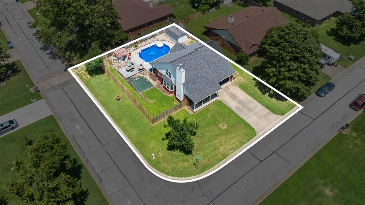 Location, location, location! This spacious 4BR/3BA ranch-style gem sits on a prime corner lot in sought-after Pleasant View Estates in SE Bentonville. With approx. 1,880?SF on a level 0.23-acre lot, this home offers a perfect blend of comfort and convenience. The spacious, open living area features a cozy gas fireplace, and the eat-in kitchen boasts generous cabinet space. The main level includes a primary suite, a guest bedroom, and a guest bathroom for added flexibility, plus an attached 2-car garage. Step outside and prepare to be impressed—your own backyard oasis awaits! Enjoy the 10,000 gallon in-ground pool, patio, playhouse, and storage shed—all within a fully fenced yard perfect for entertaining, relaxing, or family fun. Just minutes from downtown Bentonville, Crystal Bridges, world-class biking trails, top schools, I-49, and Walmart HQ, this home puts you in the heart of it all. Don’t miss this incredible opportunity to own in one of NWA’s most desirable locations!