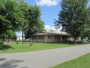 Beautiful maintenance free brick home. 3 bed, 2 bath with gorgeous hardwood floors and granite counter tops throughout. Nice trees, large fenced yard, nice outbuilding. Very handy location! Includes nice storm shelter just off the garage.