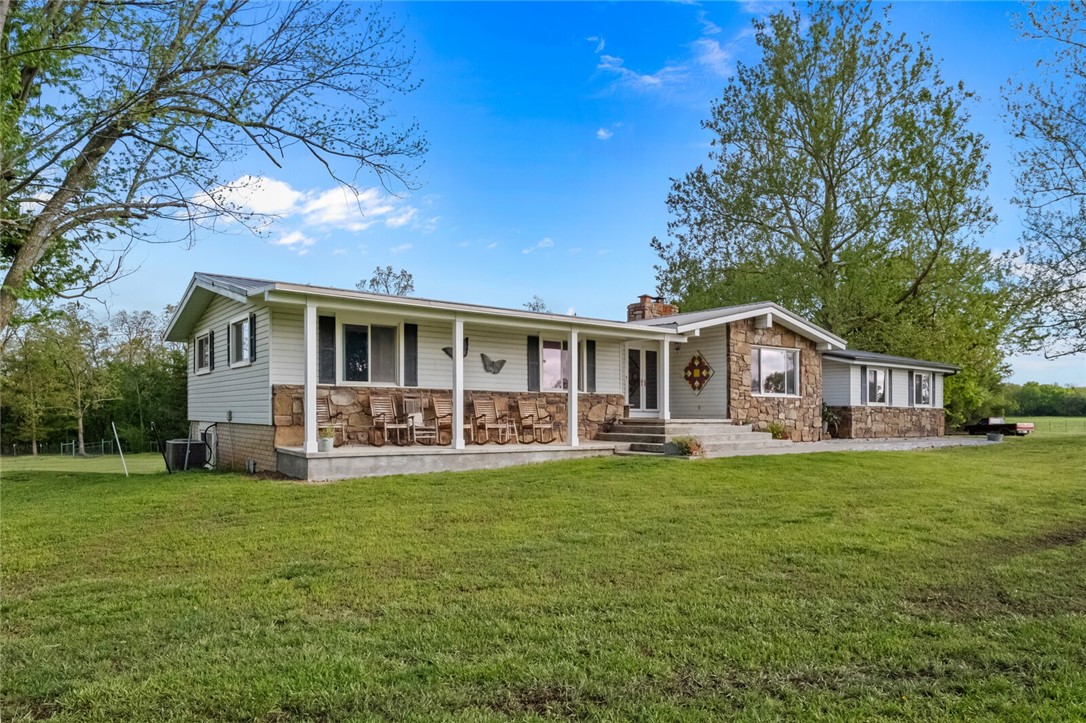 Come home to it all; 10.2 acres anything you can dream is here. 4000+ SF home w/ FULL basement! Metal roof/steel siding/rock, 4 yr old windows/doors, updated heat pump/AC, OZARK GO Fiber, 2 car gar., 2 covered porches, 2 chimneys, French drain, whole house filtration system. Upstairs: 2200+ SF, 4 BR/2.5 BA, office, stone fireplace, 2 w/d hookups, granite counters w/double oven, pantry/closet, reclaimed wood floors in living room, tile/new wood laminate/carpet, stained glass fixtures, vaulted ceiling. Full basement: 1900 SF hvac, wood stove, storage, utility sink, floor drain, walk-out doors. SHOP: 20x30ft, 110/240 power, restroom, wood stove hook-up.Gated w/mature trees, well and rural tap pd/avail. Conduit for landscape lighting/elect. entrance gates! 5 fruit trees/est. vineyard. 2 barns w/ loafing shed; 3 paddocks/fields fenced, water & elect. outlets for each; chicken house, raised & insulated, auto door, electricity/water spigots. 41x21 swimming pool w/commercial DE Filtration & pump. NO comm. poultry farms!