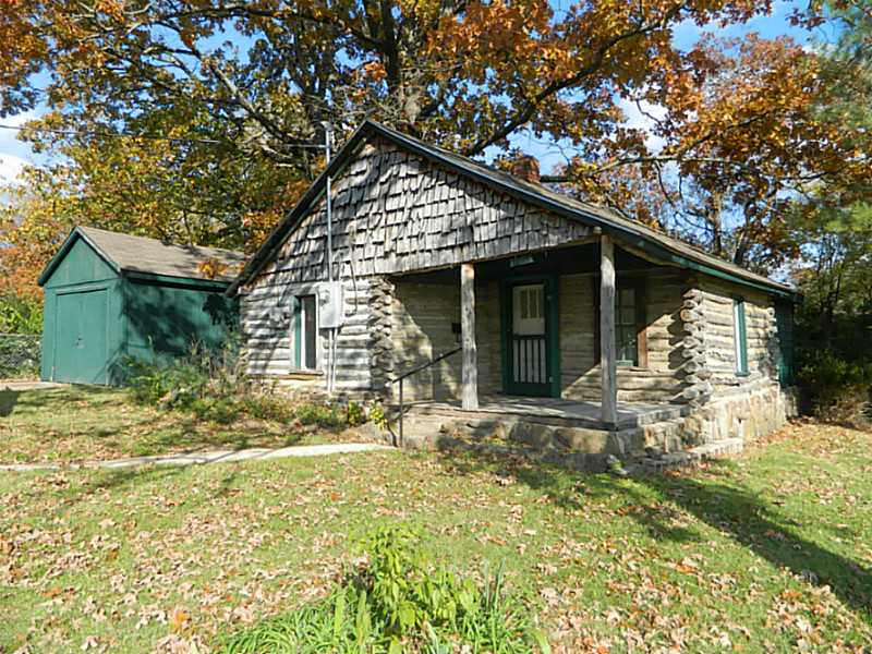 REAL LOG HOME BUILT IN 1906. BIG YARD WITH ESTABLISHED TREES. RETIRE HERE OR SPEND RAZORBACK WEEKENDS HERE FOR UNDER $44,000! 1 CAR GARAGE AND POLE CARPORT. NEXT TO THE GREATHOUSE PARK.