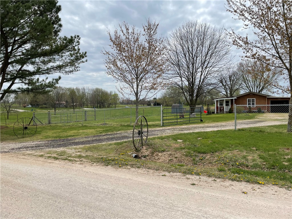 Are you looking for a peaceful setting? This property is made up of two parcels that total 4.5 acres. The single wide trailer is in good shape or this could make a beautiful spot to build a new home. The current home has Pea Ridge water, septic system, and is all electric. Most of the property is fenced in and there are various outbuildings. The location is a short drive into town but on the outskirts out of city limits. The unit is occupied so all showings will need an hour lead time. Please discuss financing with lender before viewing property due to mobile home on the property. All offers will need proof of funds letter for cash or preapproval for financing. The trailer is not on a permanent foundation. Tornado shelter does not convey
