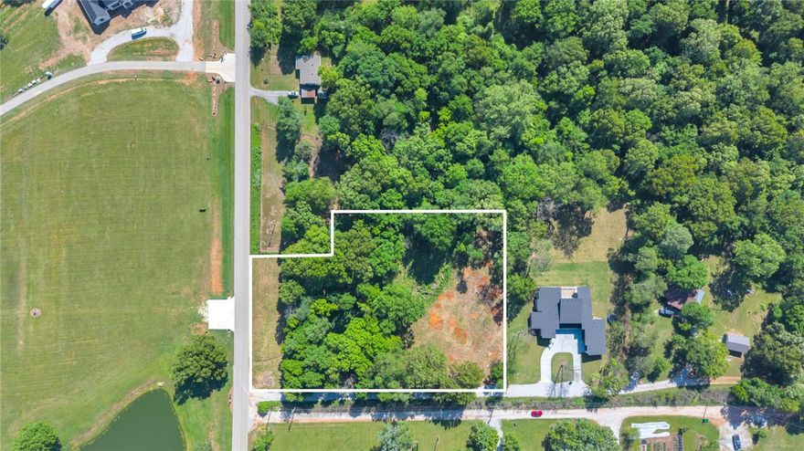 Tucked away in one of Tontitown's most convenient locations, this 2.35 acre property offers the perfect canvas to build your dream home. Approximately .7 acres of buildable space, while the remaining acreage unfolds into a wooded, sloping landscape that creates a natural buffer of privacy and a peaceful, tucked away feel. Utilities available at the road, septic needed, this property is ready for your vision. Whether you're looking to build now or invest for the future, this setting offers a rare mix of accessibility, space and seclusion just minutes from HWY 412, I-49 and nearby amenities.