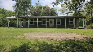 This 4-bedroom, 2-bathroom house sits on a generous 0.83-acre lot and comes with the added bonus of a large workshop, ideal for hobbyists, craftsmen, or storage. The home itself is in need of repairs but has great potential for a fixer-upper project. Despite the need for repairs, the large lot provides significant potential for outdoor improvements, gardening, or even expansion projects. With the right renovations, this home could be restored to its full potential, making it an attractive investment or a personal renovation project.
