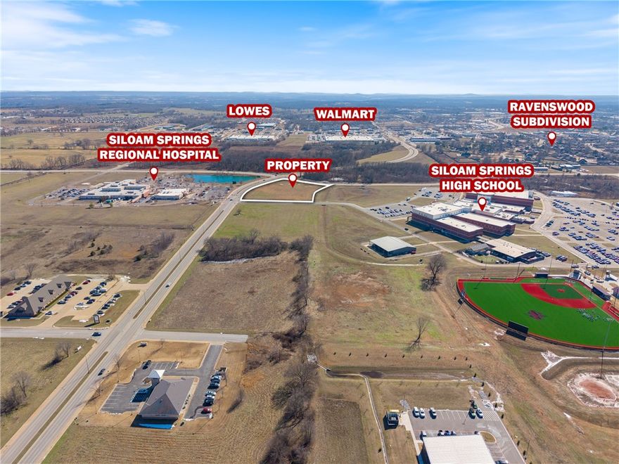 This prime +/- 4.14 acre parcel of developable land is strategically located adjacent to Siloam Springs High School, offering excellent visibility and accessibility. All essential utilities (water, sewer, electric, and gas) are readily available at the street, making development seamless. The property boasts optimal frontage on N Progress Ave (approx. 600') and Tahlequah St (approx. 350') and sits just 90ft from Siloam Springs Regional Hospital. Surrounded by high-value operators such as Walmart, Lowe's, Siloam Springs Rodeo Grounds, and Siloam Springs Golf Club, the location is well-positioned for strong commercial activity. Additionally, the Ravenswood Subdivision, a densely populated residential area, is only 1,300ft south of the site. Zoned C-2, this property is ideal for a gas station, convenience store, office or retail buildings, QSR, and more, offering endless development opportunities in a thriving area.