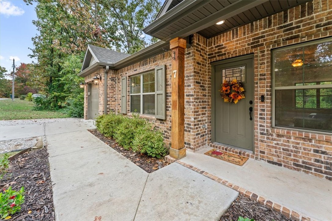 Welcome to this charming home built in 2021 at 7 Longview Ln. in Bella Vista. This two-bedroom, two-bath house features a flex room and a closet that could serve as a third bedroom. Offering 1,242 sq ft of thoughtfully designed space, you won't believe how spacious it is. The split floor plan provides privacy, and the eat-in kitchen with granite counters is perfect for casual dining and entertaining. Amenities include upgraded interior and exterior lighting, ceiling fans, crown molding in the main living space and primary bedroom, attic storage, walk-in closets, and a mix of wood, tile, and carpet flooring. Outside, enjoy the covered deck and fenced backyard. The property includes a one-car attached garage and a detached storage shed for hobbies or extra storage. The exterior combines brick and vinyl siding for a low-maintenance look. Bella Vista offers community pools, boat docks, clubhouses, nearby golf courses, trails, and more. All appliances convey. Don't miss the opportunity to own this move-in-ready home.
