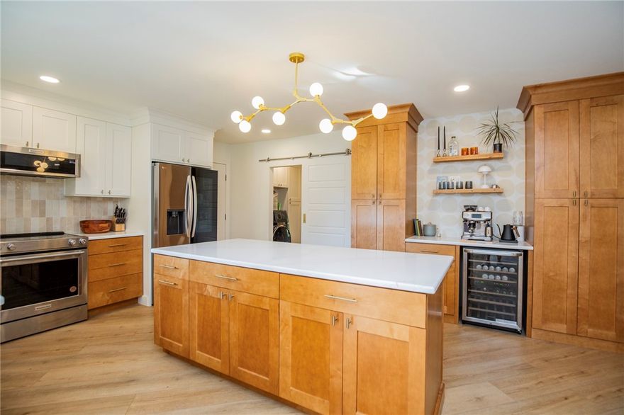 Beautifully updated with timeless finishes rarely found at this price point! Seamless flooring flows through the open-concept living, dining, and modern kitchen, creating an inviting and cohesive space. The kitchen impresses with quartz countertops, stainless steel appliances, and high-end cabinetry featuring pull-out shelving behind nearly every door. The offset dining area opens to a light-filled living room anchored by a stunning sandstone fireplace, while a sliding glass door leads to an L-shaped sunroom/bonus space. The primary suite offers a spa-like retreat with a custom tile shower, garden tub, dual vanity with fog-less mirrors, and custom window treatments that continue throughout the home. Two additional bedrooms share a hall bath finished to the same standard, with the front bedroom freshly painted. All this, just a short walk to Loch Lomond Marina, 300 ft. from the “Tunnel Vision” MTB Trail, and only a mile to Loch Lomond Dam Park with dog park access! 5 min drive to I-49 bypass. New roof 2021.