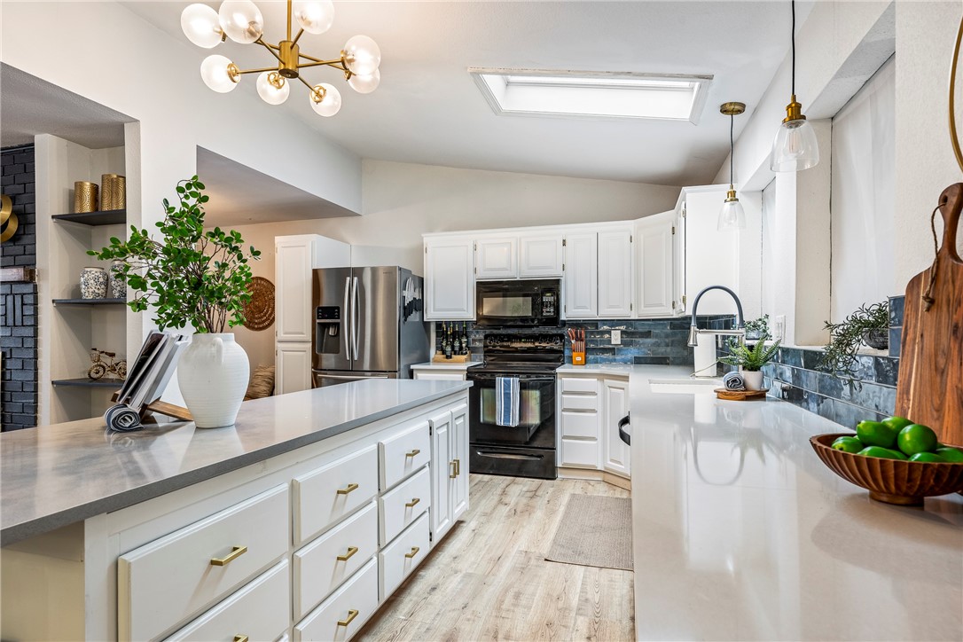 Updated charming Mid-Century Modern vibes in Bella Vista! This home boasts a stunning stone wood-burning fireplace in a spacious, open living area. The kitchen shines with a large island, sleek modern fixtures, and quartz countertops. Relax in the spa-like primary bath featuring a soaking tub and separate shower. There are 3 bedrooms and office along with 2.5 baths. A sunroom offers serene views of the flat, wooded backyard, plus a heated office with a mini-split for year-round comfort. Highlights include high-efficiency HVAC, Anderson windows, Pergo laminate flooring, and a new mini-split. The backyard storage building doubles as a cozy workshop. Home is on a 2-bedroom septic.