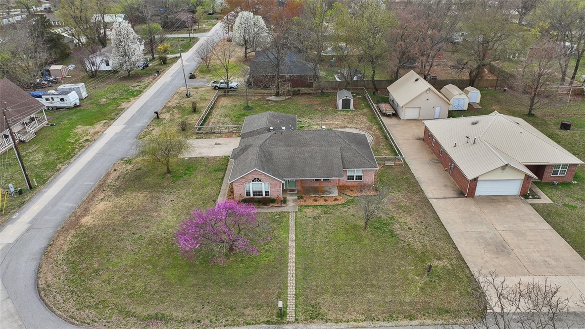 Wowza! This home is ready for its new owners! This over half acre corner lot is spacious, partially shaded, and great for life and entertaining. The homes updates include new roof, led lighting, new hvac, new carpet, fresh paint, fresh landscaping, and more on the attached amenities sheet! You will feel safe in the interior storm shelter, disguised as the hall bath ;). The primary is spacious and has a huge closet. The open floor plan and vaulted ceiling hosts an abundance of room for furniture layouts. The garage door is an extra 2' tall to fit a utility van, vehicle roof racks, or lifted off road vehicles. Refrigerator, Washer and gas Dryer negotiable. Prairie Grove is a small town packed Big amenities. The home is walking distance to the historic downtown, restaurants, grocery store, and parks. The owner is throwing in a one year family season pass to the Prairie Grove aquatic Park just a few blocks from the home! Price reduction below comps at closing due to questionable appraisal, not the properties condition.