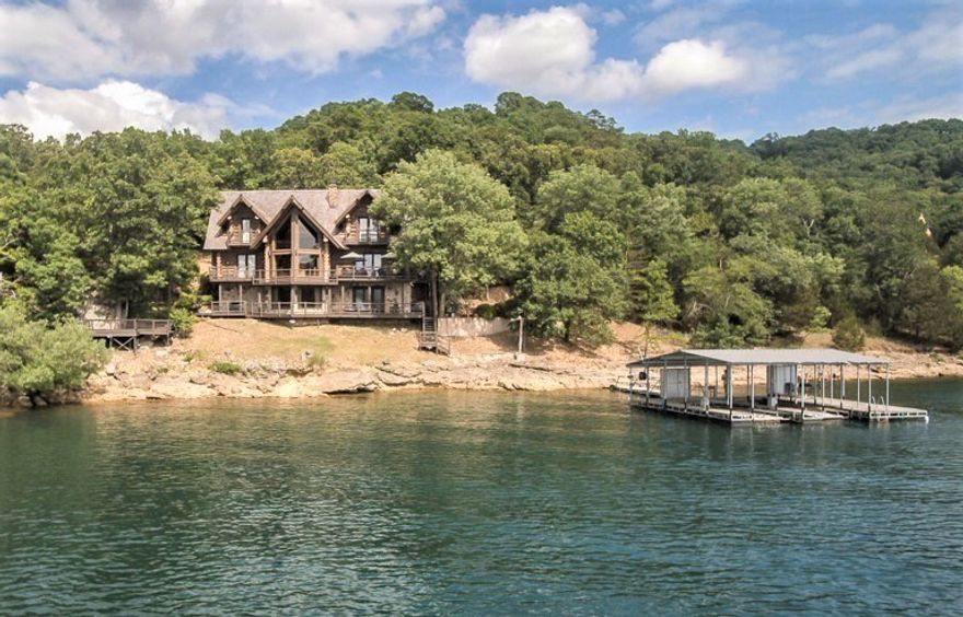 This magnificent Rocky Mountain Log Home, constructed of 15-inch Swedish cope logs, is unrivaled in its craftsmanship. A 30-foot stacked stone fireplace serves as the main focal point and floor-to-ceiling boat prow windows bring the spectacular view indoors. The gourmet kitchen with a Subzero refrigerator and gas Wolf stove, and the adjoining hearth room is a wonderful place for entertaining. Spacious decks stretch across the back of both levels, and private balconies offer dramatic views from the upstairs bedrooms. The two-slip private dock is just steps from the back deck and is equipped with electric service, lifts, lockers and a swim deck. It's a rare lakefront property with easy lake access and a very low take line. A detached garage provides storage for your lake toys and extra vehicles and the carport easily accommodates two cars at the front door. World-class trout fishing is minutes away on the White River, 15 minutes to downtown Eureka Springs, 35 minutes to Rogers and less than an hour to Branson.