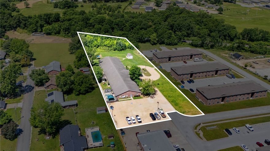 Exceptional opportunity to own a well-maintained commercial daycare property in the heart of Gentry. This versatile property is 13,788 Sq Ft. and is thoughtfully designed to accommodate daycare operations or a variety of other approved commercial uses. The functional layout includes flexible spaces for classrooms, offices, activity rooms, or meetings, along with a well-equipped kitchen featuring a central island and prep sink. Additional features include a dedicated laundry area, ample storage, practical workspace areas, and an attached carport for convenient covered parking and drop-off access. The private yard with patio and porch areas provides great outdoor space for recreation or gatherings. With its established setup, excellent condition, and convenient location within a growing community, this property presents an outstanding investment or owner-user opportunity.