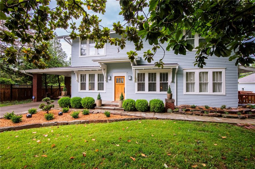 Be a part of Bentonville’s history in this exquisitely restored Prairie-Craftsman farmhouse, once the heart of a 500-acre apple orchard. Every inch honors its 100-year-old charm—original wood floors, high coffered ceilings, wainscotting, restored double-hung windows—while delivering the peace of mind of a top-to-bottom renovation: updated plumbing, electrical, HVAC, foundation, roof (2024), and more. Designed by Nico Interior Design, the home blends elements like soapstone, Carrara marble, and custom local black walnut cabinetry with timeless craftsmanship. The main home offers spacious living and dining rooms, four bedrooms, spa-like baths, and a chef’s kitchen. The vaulted coach house adds versatile space for a studio, office, or gym. Outside, a wrap-around 1,200 sqft deck, native stone patios, and lush gardens create a park-like setting on one acre—just minutes from Crystal Bridges, Orchard Park, and the Square. A turnkey historic treasure ready for modern living.
