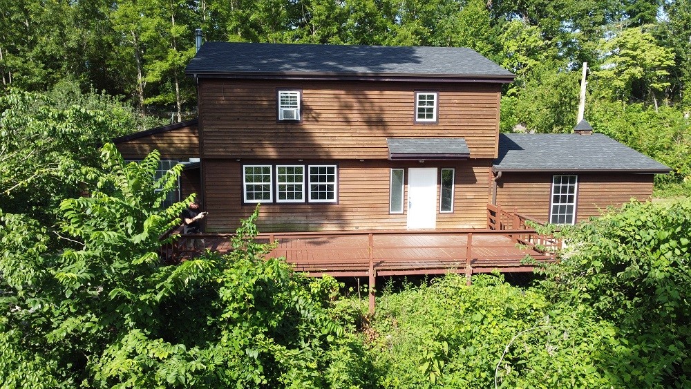 Hard to find 9.10 acres with updated 1996 sq. ft. home! Current Owners' plans changed so your gain! Enjoy the privacy of country living with an easy 17 mile commute from downtown Rogers via scenic Highway 12 East. New interior work includes drywall/trim, paint, butcher block counters, ceiling fans, refinished wood floors, LVP flooring in the baths and new roof 2024. The hillside area off the large deck can be further terraced and cleared for an ideal garden spot with trails to explore. Extras include the reverse osmosis water system, 2 car garage and outbuildings, along with the fig, fruit trees & wildflowers to complete the homestead. So much potential & ready for new owners! **To Be Addressed - Sellers are offering a Buyers credit/concession of $6,200 in lieu of one new AC unit OR will escrow $6,200 at closing to have it installed per professional bid; the other unit has been serviced and is in working order.