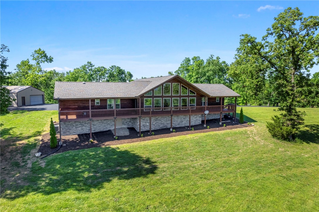 This immaculate 3/2.5 home on 16+/- acres w/ year round views overlooking beautiful Beaver Lake is the gem you've been waiting for! The 16 acres is on 2 parcels & both parcels have their own septic & well. W/in 3 mins to the public boat launch. If you have a boat the 30X40 insulated shop building w/ 1/2 bath is perfect to protect & store your boat & other toys. The shop building also has a full RV hook up by it so plenty of room for guests traveling. You'll love the cedar sided home w/ a massive covered deck over looking the lake. The home itself is well planned w/ open floor plan highlighting the floor to ceiling windows w/ views that will take your breath away. Kitchen has granite counters, an island & very large pantry. The home is a split floor plan w/ the owners suite being overly large & room for sitting area. The bath itself offers 2 walk in closets, 2 vanities, shower & whirlpool tub. Pictures don't capture the ambience. Too much more to mention. Come & see this before its gone!