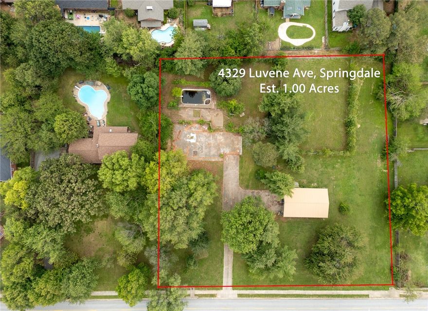 Wooded acre, in-ground pool, shop already on site—and it’s next door to one of Springdale’s top schools. With quick access to I-49, you can be anywhere in NWA in minutes. An old foundation is still in place, offering a possible jumpstart for your next build. Whether you’re looking to start fresh or make use of what’s already here, this spot puts convenience and opportunity in one place. This is also listed seperatley. With old shop MLS#1309974 / with old foundation MLS# 1309978. Shop is currently being leased month to month and can be shown upon accepted contract