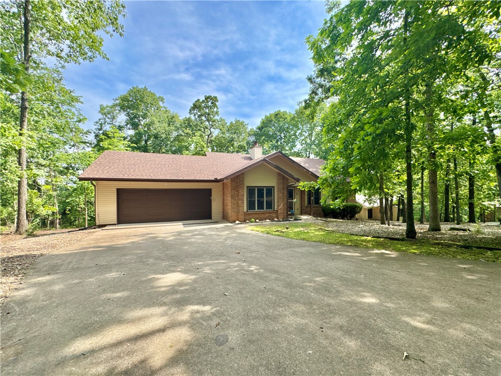 Discover this well-maintained 3 bed, 2 bath home located in a quiet, friendly Bella Vista neighborhood near Lake Loch Lomond. Enjoy a serene “treehouse” view from the deck. Solar tubes fill the kitchen and living room with natural light. Recent updates include a new roof, gutters, and deck in 2025. The long driveway leads to a newly insulated two-car garage with an additional finished space; perfect for a workshop or studio. Just a short walk to Lake Loch Lomond’s marina and Lakepoint Restaurant. Enjoy nearby access to mountain bike and hiking trails, and Scotsdale Golf Course only minutes away. A perfect blend of peaceful living and outdoor adventure!