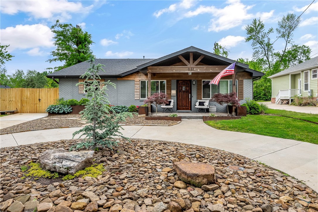 Coveted Historic Downtown Bentonville location, just steps from the square. Beautifully remodeled home contains a Chef's kitchen with 6 burner gas cooktop, apron sink, double ovens, and sea of cabinets for storage. The open-concept floor plan in this home is perfect for entertaining. This home has 3 spacious bedrooms plus a large office and beautiful sunroom. The landscaping boosts custom built metal landscaping boxes in the front and backyards. The backyard has a wonderful pebble patio with a fire pit. You also have an enclosed side area to be used for parking or other storage. The backyard contains a shed great for storing all your bikes and equipment. This home boasts luxury and accessibility to arts, entertainment, dining and grocery all within walking distance from your front door. This is the perfect family home in Downtown Bentonville, schedule your showing today!