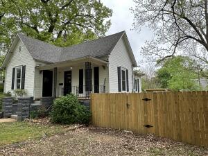 This is such a cute home located in Cotter. Two bed, two bathroom large older home with so much charm. Located on five lots. Large living room with many wood details. Master bedroom with attached full side bathroom. Fenced in back yard with chicken coop and storage shed. Close to The White River.