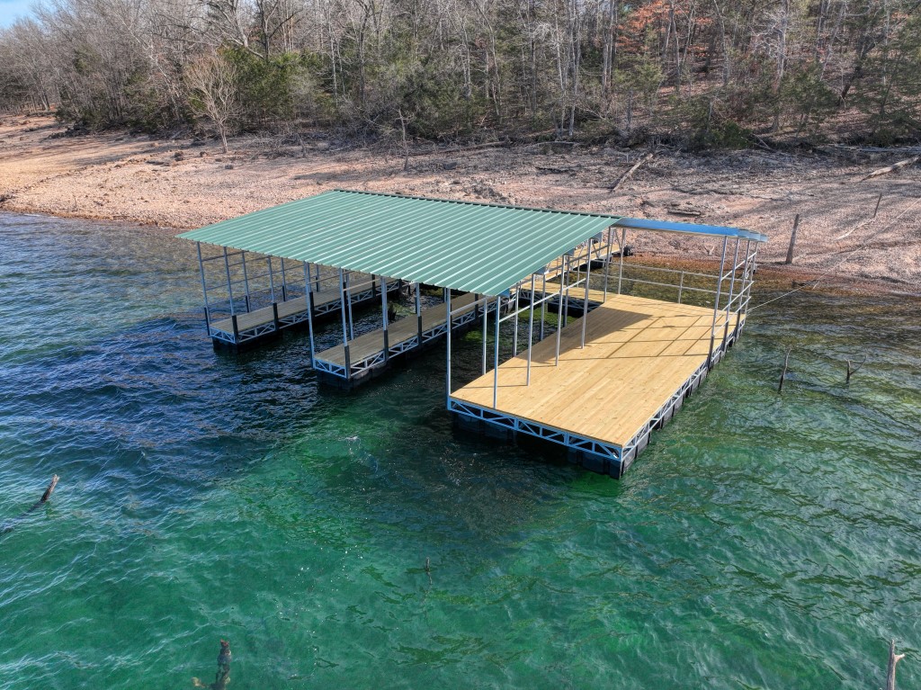 This beautiful lake front lot has an incredible view, a very low Corps of Engineers take-line, and a BRAND-NEW PRIVATE DOCK! This unbelievable pairing is the perfect place to build your dream lake house. This dock is probably one of the last few new dock permits that will ever be approved for Beaver Lake! Its construction was recently completed and delivered to this site. Two 30ā long slips and the maximum size swim deck will make your summer days a blast! This lot is located at the very end of a paved road, near the tip of this peninsula. The low take-line means you can build and drive closer to the dock and you can also thin out most of the trees in order to uncover the impressive view! This is your dream lot. There will not be many like it in the future of Beaver Lake!
