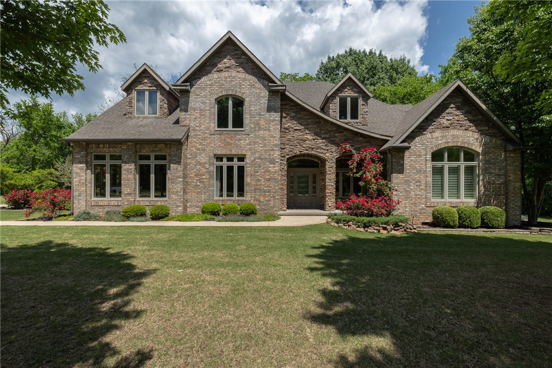 Welcome to life in The Knolls—where timeless style meets natural beauty just 15 mins from Fayetteville. This elegant multi-level home offers warm, light-filled spaces, hardwood floors, & classic finishes throughout. Main level features a stunning living area with a stacked stone fireplace & views of a tree-lined backyard. Entertain in the formal dining room or cook in a chef-worthy kitchen with granite, travertine, SS appliances, & breakfast nook. Private owner’s suite offers spa-like comfort, while upstairs features a game room, bar, multiple bedrooms, & French doors opening to spectacular decks with panoramic views. Third level opens to a spacious room with a full bath—ideal as a fifth bedroom, studio, or guest suite. Professionally landscaped with a new roof coming soon, this home offers both beauty & peace of mind. Set on a quiet lot with mature trees, enjoy the feel of country living plus access to trails, pool, pool house, tennis & pickleball courts. A true Fayetteville retreat with space, comfort, & style.