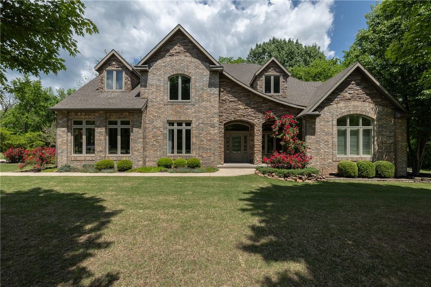 Welcome to life in The Knolls—where timeless style meets natural beauty just 15 mins from Fayetteville. This elegant multi-level home offers warm, light-filled spaces, hardwood floors, & classic finishes throughout. Main level features a stunning living area with a stacked stone fireplace & views of a tree-lined backyard. Entertain in the formal dining room or cook in a chef-worthy kitchen with granite, travertine, SS appliances, & breakfast nook. Private owner’s suite offers spa-like comfort, while upstairs features a game room, bar, multiple bedrooms, & French doors opening to spectacular decks with panoramic views. Third level opens to a spacious room with a full bath—ideal as a fifth bedroom, studio, or guest suite. Professionally landscaped with a new roof coming soon, this home offers both beauty & peace of mind. Set on a quiet lot with mature trees, enjoy the feel of country living plus access to trails, pool, pool house, tennis & pickleball courts. A true Fayetteville retreat with space, comfort, & style.