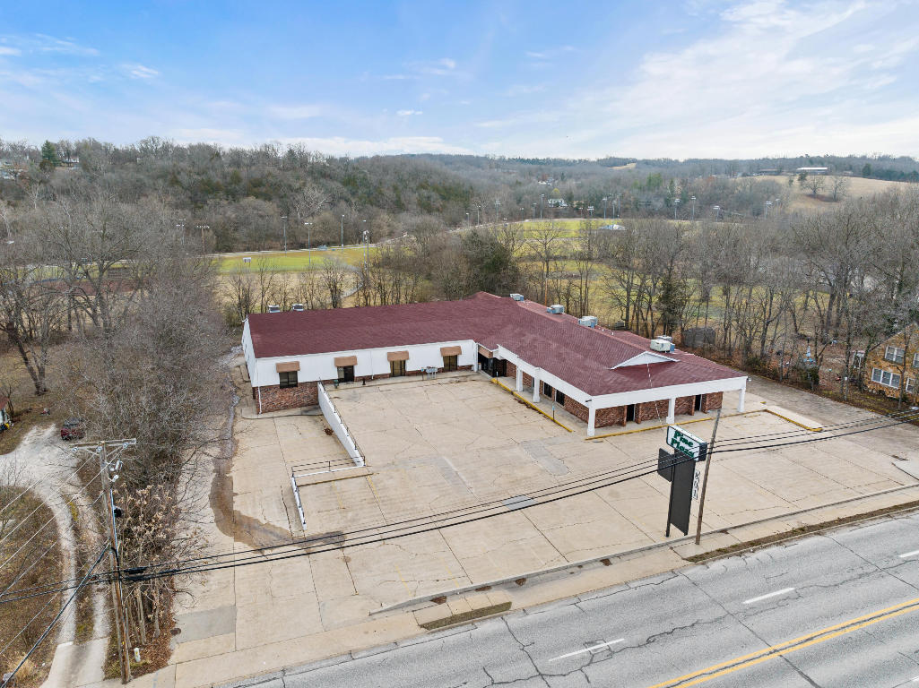 Seize the Opportunity with this commercial property! Looking to expand your business or start anew? This property gives you the availability to develop from 2,000 sq. ft. to almost 7,000 sq. ft. the way you dream of it while having the benefit of residual income already in place with the possibilities of adding even more income. Over 13,000 sq ft office space with 6,000+ sq. ft of basement with 10 ft. overhead door. 1.54 acres close to downtown Harrison. Some recent updates include a partial roof replacement in 2016 and 2022. Also, in 2022-replaced two 5-ton HVAC units, all exterior painted and several suites remodeled complete with new flooring and paint. So much more than meets the eye with this property!