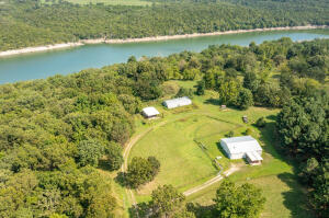 Never been offered before - Barndominium! Outbuildings, 2 drilled wells, park like setting, 60 acres surrounded by the Bear Creek Arm of Bull Shoals Lake. Wild Life. 30 minutes to Branson Missouri. Dream Location!