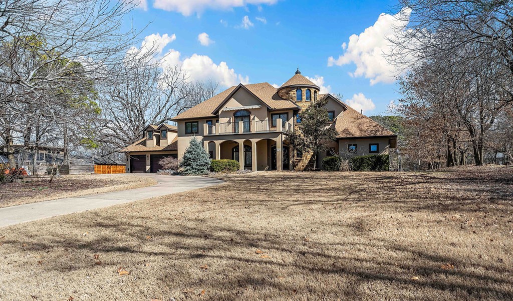 Discover 608 N Sequoyah Dr, a stunning Mediterranean-style custom home in Fayetteville, AR, brimming with luxury. Step onto elegant marble floors that guide you to a flexible dining/art room and a grand living area with vaulted ceilings and a cozy seasonal fireplace. The semi-professional kitchen boasts a Miele coffee center, speed oven, Sub-Zero Pro G 48 fridge, Blue Star commercial stove, jatoba wood-finished storage, and a walk-in pantry. Adjacent lies a family room and breakfast nook opening to a large patio with a ceiling fan and gas grill hookup. The main level offers a king-sized bedroom with a walk-in closet and a lavish bathroom featuring Grohe fixtures, Villeroy & Boch sinks, a Jacuzzi tub, and a walk-in shower. Upstairs, find four bedrooms with walk-in closets, three bathrooms with radiant floor heating, and a central bedroom with a hot steam bath. Highlights include Anderson Eagle low-E windows, soy-based insulation, and a new 2024 roof.
