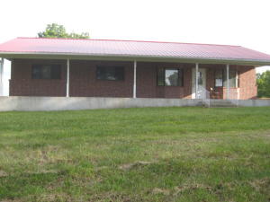 Beautiful distant views; full unfinished walk out basement plumbed for another bath room; central heat & air with back up wall heater (propane); detached workshop; insulated; concrete floors; full bath; large front porch & deck; built in safe; refrigerator stays.