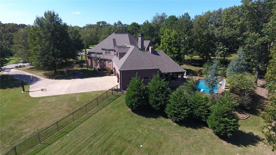 This fantastic quality one owner custom built home in Talamore on nearly 4 acres has 4 bedrooms, 5.5 baths and newly renovated spacious eat in kitchen.  The 3 car side load garage provides great curb appeal. The large rooms throughout and spacious master suite are full of cozy comfort.  Enjoy the fully fenced private backyard and heated inground pool with slide, diving board, and automatic cover for easy opening and closing. The huge covered back patio contains a wood burning fireplace, pool half bath,  grill, outdoor kitchen, for great entertaining. The study/office and excersize rooms could be 2 additional bedrooms. This home has it all! Please remove your shoes for all showings.