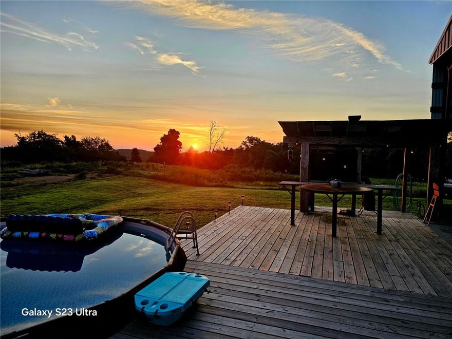 Welcome to your gorgeous Ozarks views! Step into barndominuim living at its finest. Situated on 13.76 acres, this 1 BR 2 BA converted hay barn is unmistakably unique and has so much to offer. There is a good mix of woods and pasture with 2 ponds and workshop space to boot. There are established garden beds, an amazing outdoor kitchen on the deck with gorgeous views of the surrounding mountains. All the logs, doors and stairs are recycled from 100+ year old cabin. There is gorgeous recycled barnwood tastefully added to the interior decor. The tub in the downstairs bath is a customized stock tank. The gorgeous tile 6 x 6 shower upstairs is complete with a large rain head shower. Behind the wood stove is a handmade steel heat place with a gorgeous custom mantel. The custom island is steel and concrete and includes the gas cook top. There is a built-in electric oven. Walk out onto the deck that leads to your pool and gorgeous outdoor kitchen. Additional 39.95 acres available.