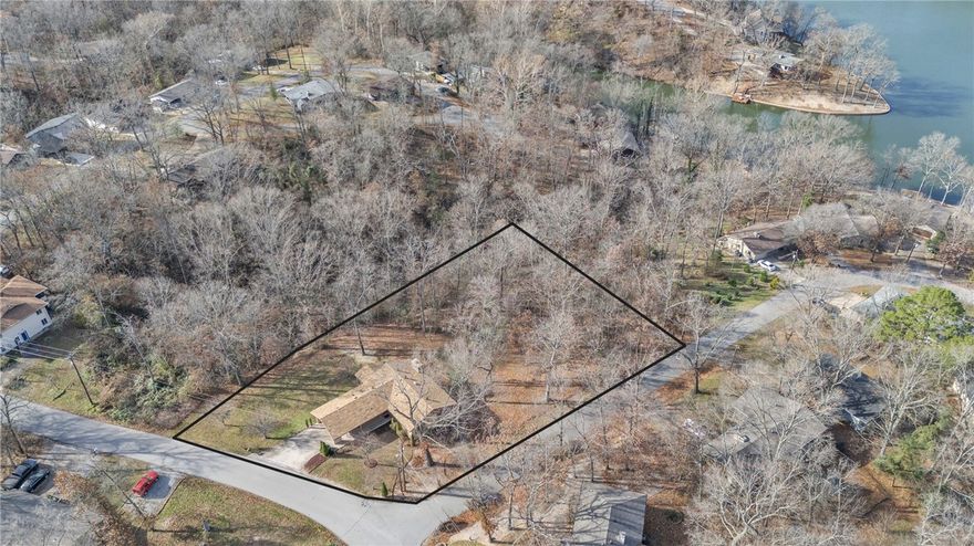 Hard to find 3-bedroom, 2-bathroom home in Bella Vista with two additional lots (approx. .88 acre) for incredible privacy - backing up to POA land in a quiet neighborhood of lake area homes. Situated just 2 miles from  town center, this property offers instant access to the outdoor lifestyle, with the Lago East trail (connecting to Tunnel Vision and Tanyard Creek) just steps from your driveway, plus access to all of Bella Vista's amenities. Inside, features include LVP flooring, kitchen with a 5-burner propane stove, and a cozy living room highlighted by a wood-burning fireplace vented to heat the entire home and Hunter Douglas motorized/programmable blinds. 2x6 construction and solid-core doors throughout. Relax on the screened porch offering a seasonal view of Lake Avalon. Basement makes a great workshop with plenty of other space for extra storage.