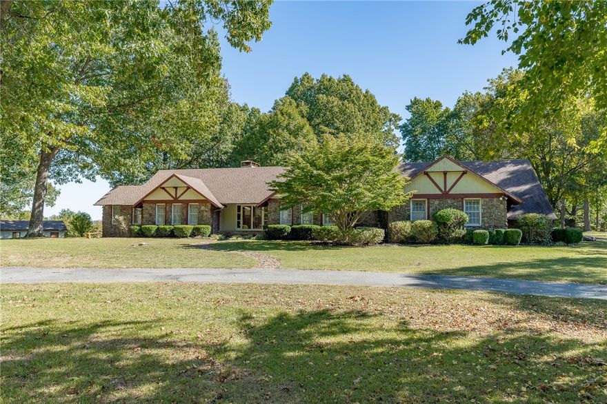 Picturesque estate nestled on 4.62 countryside acres in sought after East Fayetteville. Watch the sunrise each morning while 80 mature trees and a natural stone stacked wall provide privacy for the property so you can enjoy the breathtaking views offered from the backyard. This 3 bedroom, 3 bath home has incredible bones and would be the perfect project for those looking to renovate a home! Wooden beams and a natural stone fireplace with built-ins on both sides add to the charm of this ranch style home, with an additional large office, formal dining room and mud room making this space the ultimate package. French doors lead out the back patio offering unlimited views with level acreage that allows you to dream big. This property is also ideal for future expansion or a new development. Whether that’s your home, a wedding venue, or potentially a set of new builds — this property checks all the right boxes!